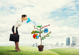 Young businesswoman outdoors watering drawn growth concept with can