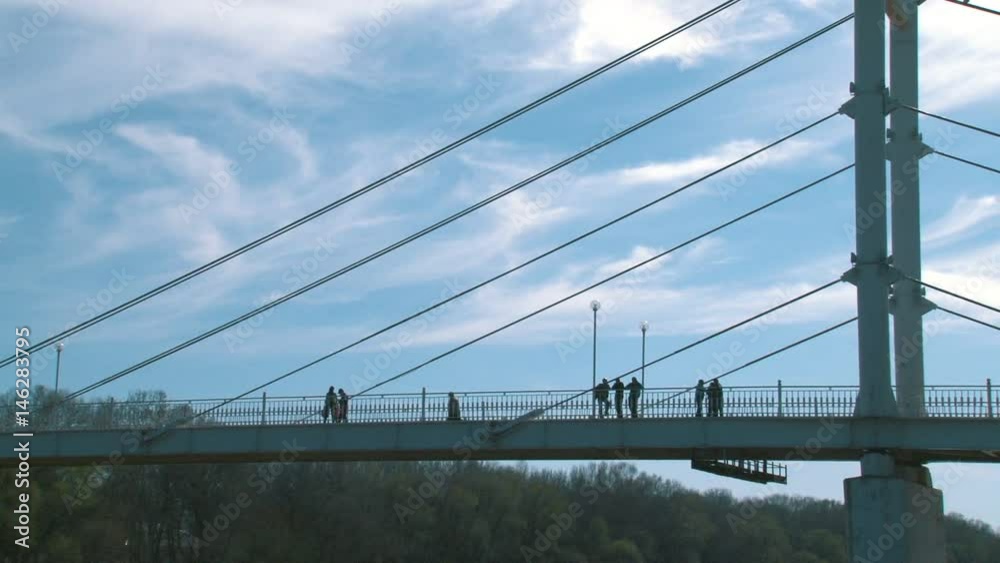 White pedestrian bridge crossing the Ural river White pedestrian bridge crossing the Ural river