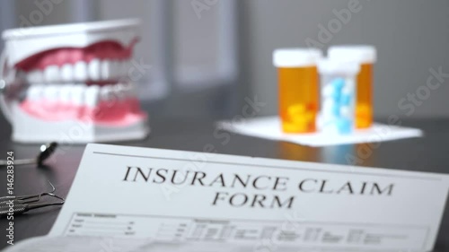 Insurance claim form on dentist's desk focus pull. photo