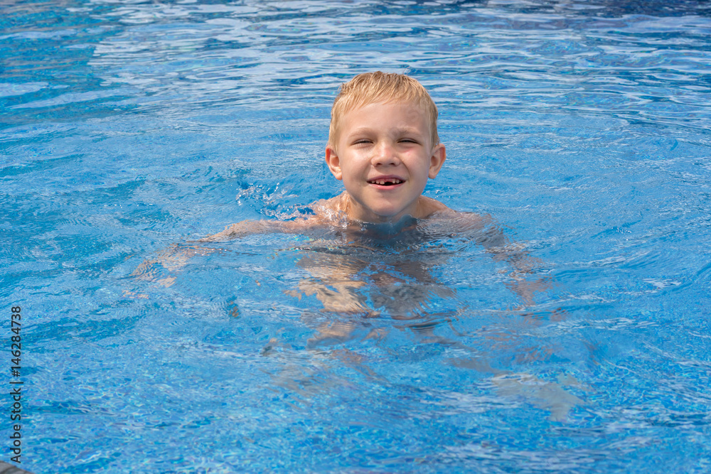 Boy swimming and playing in a pool Boy swimming and playing in a pool