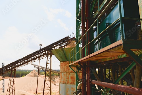 Quarry aggregate and conveyor belts. Construction industry. Horizontal photo.