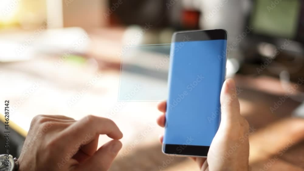 A Homeowner Uses A Home Controlling and Security Application on the smartphone A Homeowner Uses A Home Controlling and Security Application on the smartphone
