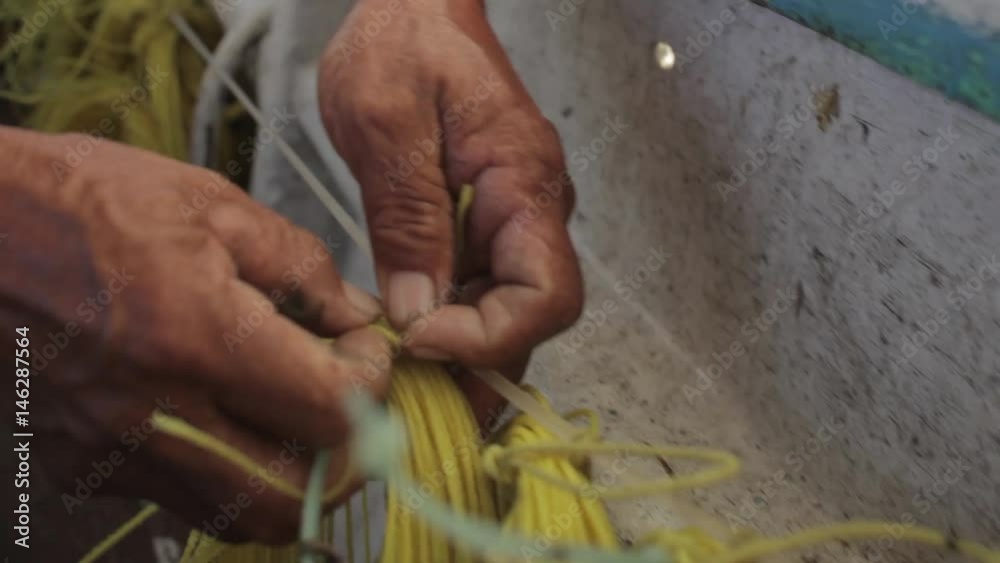 old hands working with fishing line in mexico old hands working with fishing line in mexico