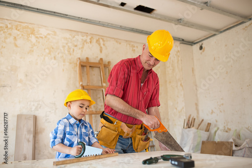 Grandfather and grandson as a dream team in the workshop