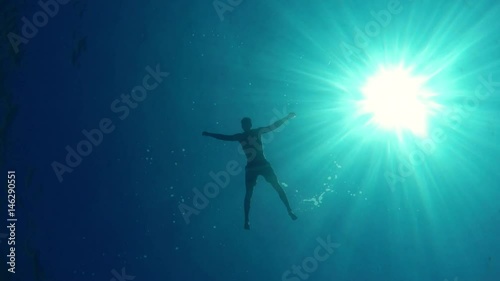 A man is diving in the blue sea - 5