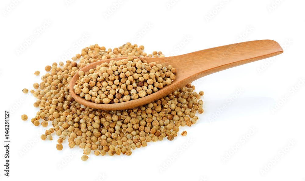 Coriander seeds in wood spoon on white background Coriander seeds in wood spoon on white background