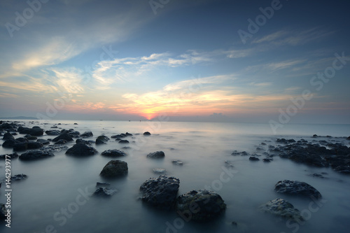 early morning sunrise near stone beach