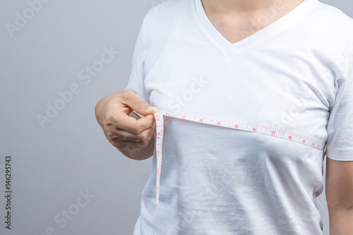 Woman measuring her small breast size