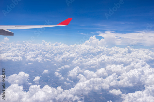 Aerial view of an airplane flying over a cloud.