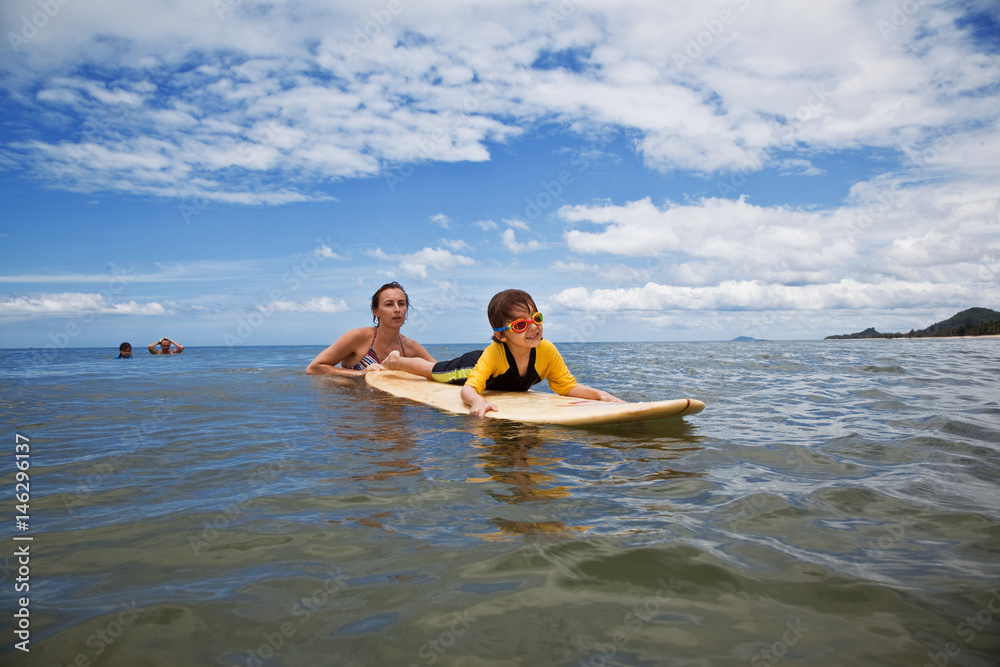 Obraz premium Family on vacation. Family Surfing. Summer holidays.