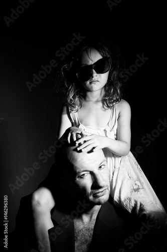 Father and daughter in gang style, dark light