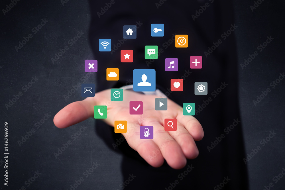 Businessman holding colorful applications Businessman holding colorful applications