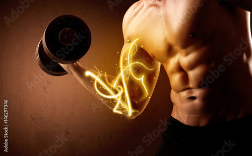 Tableau sur toile Muscular body builder lifting weight with energy lights on biceps