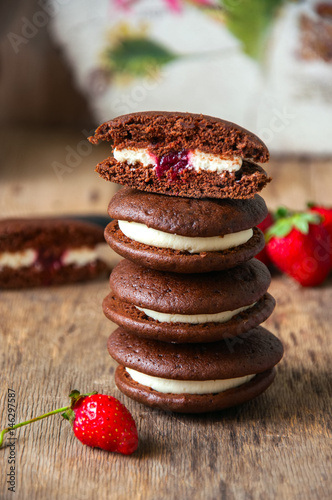 Chocolate whoopie pies with vanilla cream cheese and strawberry jam photo