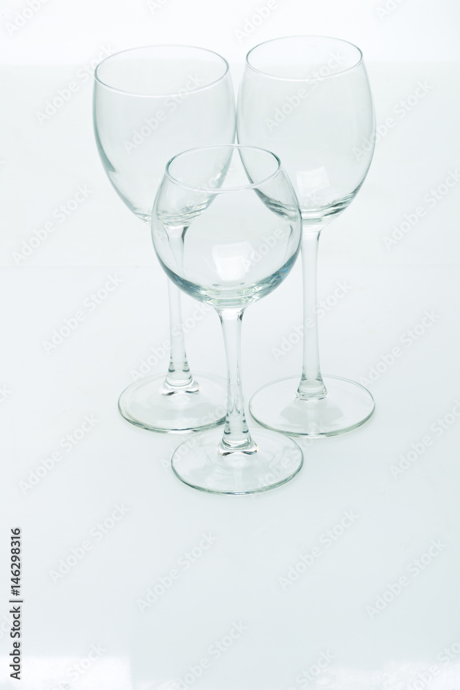 Grapes and three glasses for wine on a white background, studio light