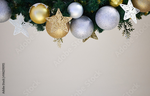 Christmas Border - tree branches with golden baubles, stars, snowflakes isolated on white. Merry Christmass and Happy New Year concept.