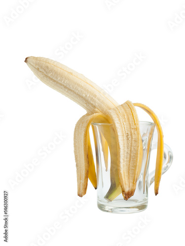 Peeled sadly banana bend in a glass cup