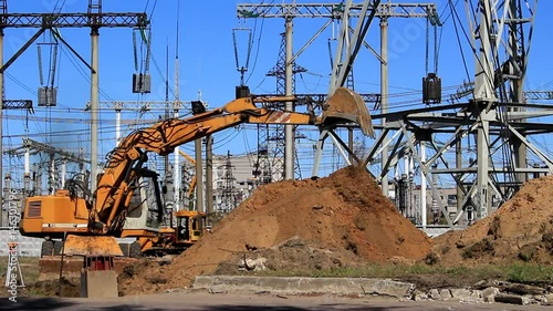 The excavator digs a trench to install the support of high-voltage lines.