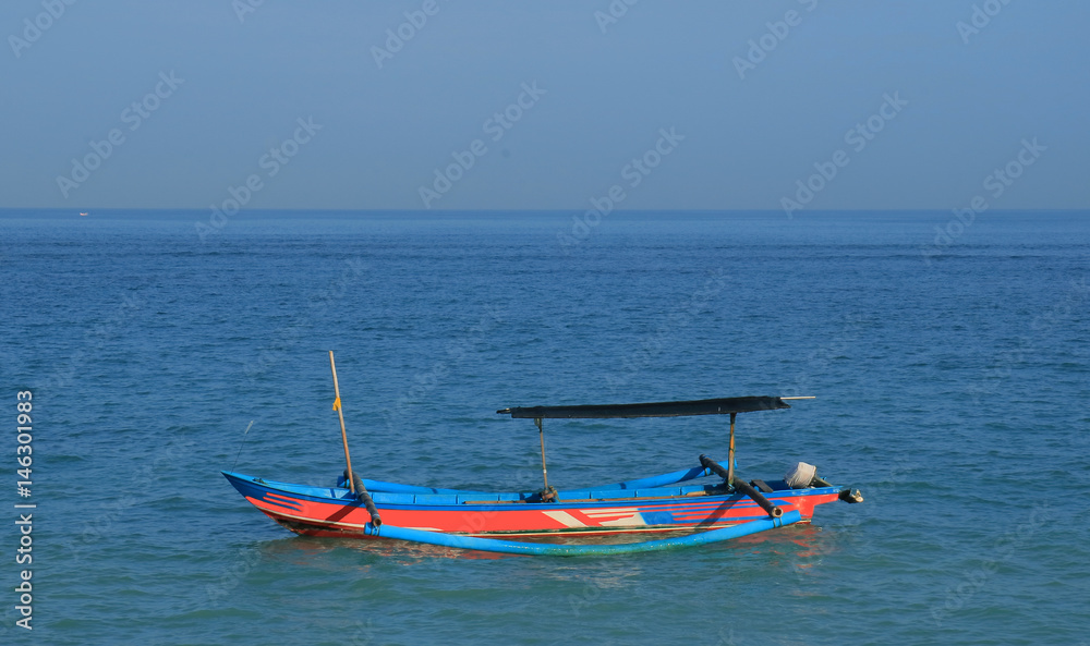 Traditional fishing boat or jukung at Kuta beach, Bali, Indonesia.