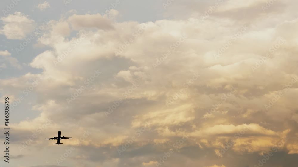Passenger airplane taking off at sunset against the background of a very beautiful clouds. Passenger airplane taking off at sunset against the background of a very beautiful clouds.
