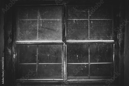 Black and white picture of the old dirty window