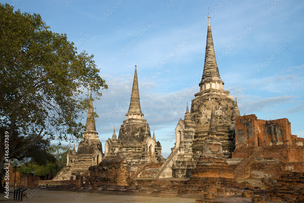 Three ancient stupas of the Buddhist temple of Wat Phra Si Sanphet on a cloudy morning. Ayutthaya, Thailand