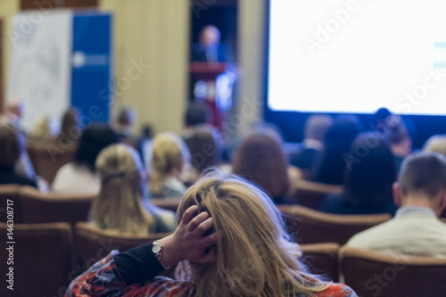 Business Conferences Concepts. Male Host Speakers Standing in Front of the Audience During the Conference.