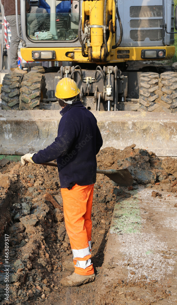 man at work and the big bulldozer in the roadwork