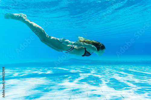 girl dive under blue water snorkeling in pool, Summer vocation