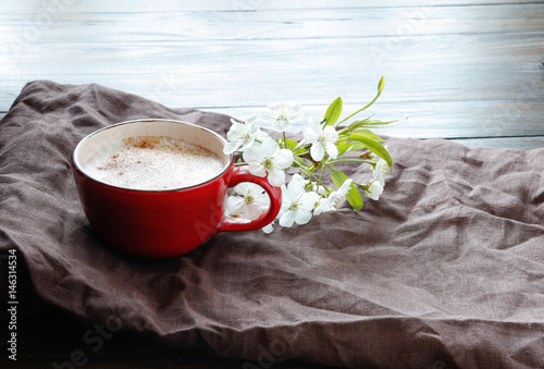 Cup with coffee and cherry blossom