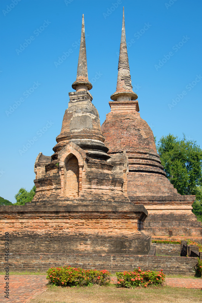 Two ancient chedi of Buddhist temple Wat Sa Si. Sukhothai Park, Thailand