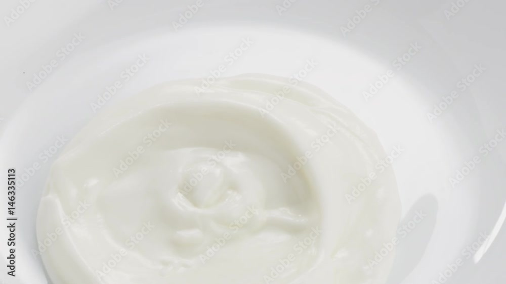 Slow motion yogurt pour into bowl closeup, 180fps prores footage Slow motion yogurt pour into bowl closeup, 180fps prores footage