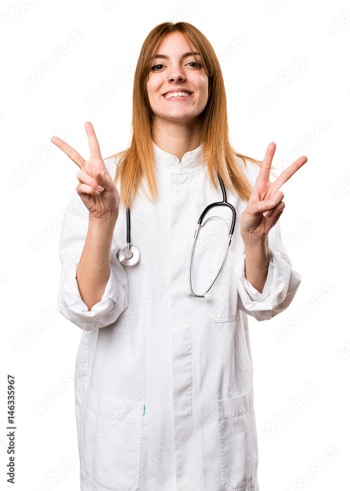Young doctor woman making victory gesture Young doctor woman making victory gesture