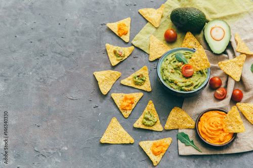 Mexican food concept: tortilla chips, guacamole and salsa over vintage background. Top view. Flat lay. Copy space © victoria