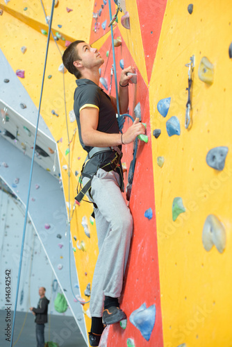 Young man on climmbing wall