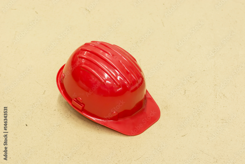 Fototapeta premium Red protective helmet lying on the floor.