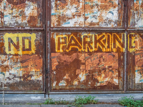 "No parking" writing on a rusty door in the Intramuros Manila, Philippines