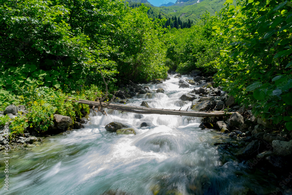 Obraz premium Waterfall in the green valley between the mountains in summer, Gorgit Highland.