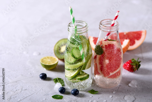 Infused detox water, healthy refreshing drink with lime, grapefruit, berries and mint