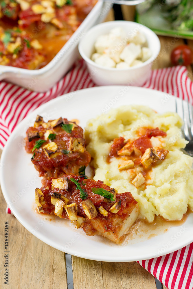 Fish cod baked in tomato sauce with feta cheese Fish cod baked in tomato sauce with feta cheese