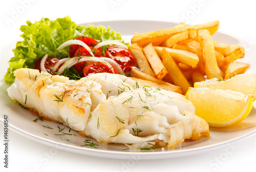 Fried fish fillet with french fries on white background