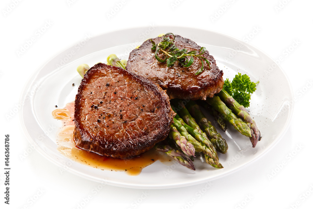 Grilled beefsteak with asparagus on white background