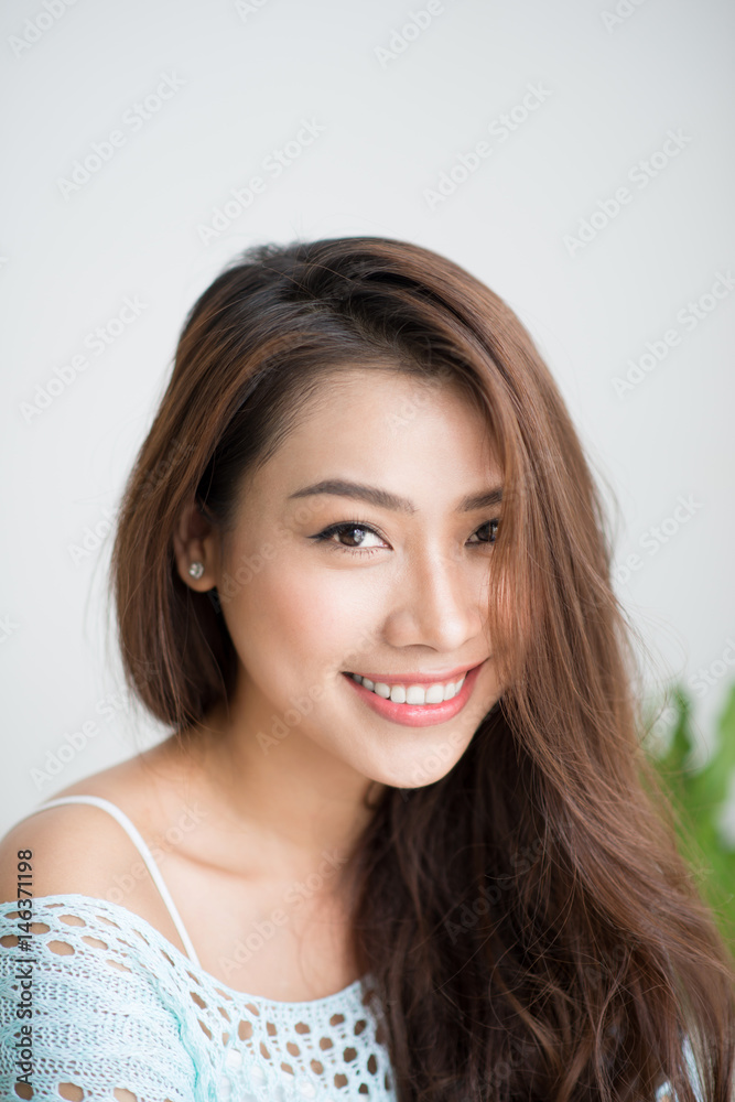 Beautiful asian woman relaxing in the morning sitting indoors. Beautiful asian woman relaxing in the morning sitting indoors.