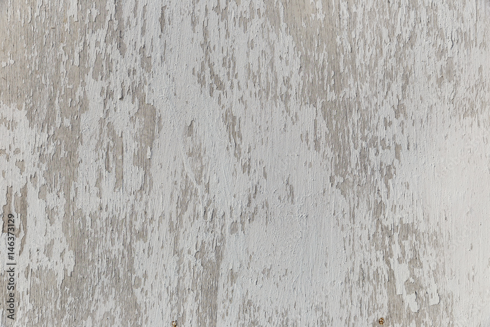 Obraz premium Old peeling white paint on a wooden board