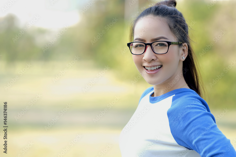 Portrait beautiful girl wear glasses in smile happy with emotional refreshing by standing outdoor garden Portrait beautiful girl wear glasses in smile happy with emotional refreshing by standing outdoor garden