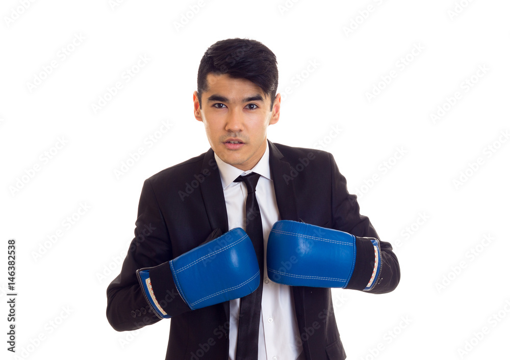 Young man in suit with boxing gloves Young man in suit with boxing gloves