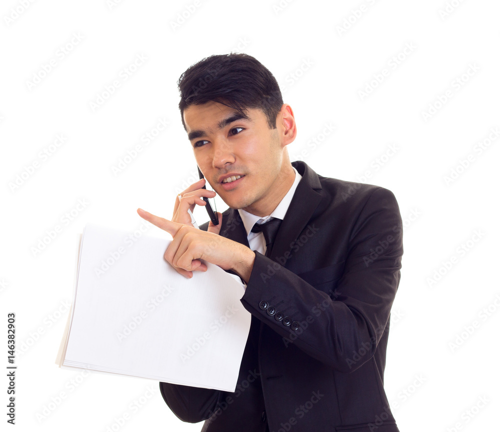 Young man in suit holding papers