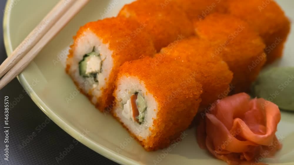Sushi roll, california rolls on a plate with chopsticks, marinated ginger and wasabi. Panorama. Sushi roll, california rolls on a plate with chopsticks, marinated ginger and wasabi. Panorama.