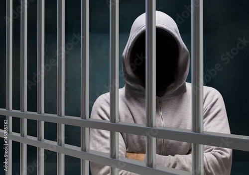 Cuadro en lienzo Anonymous Criminal in hood behind prison bars