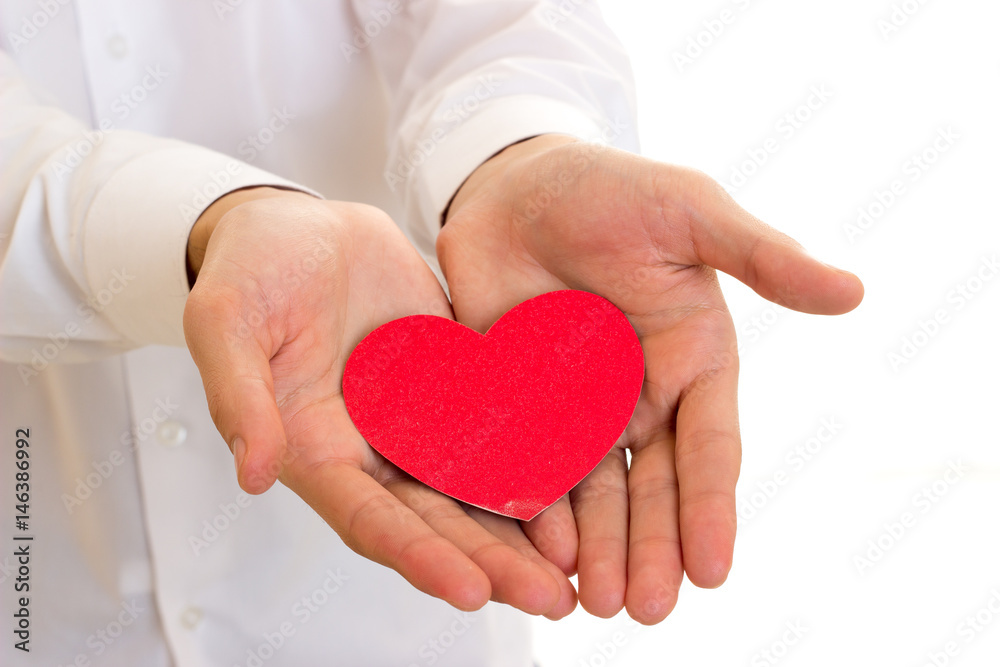 Young man holding a read heart Young man holding a read heart